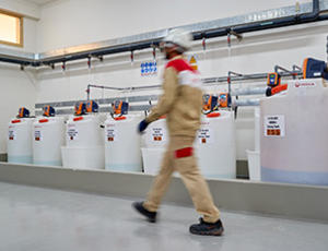 Man walking near Hydrex Chemicals cans