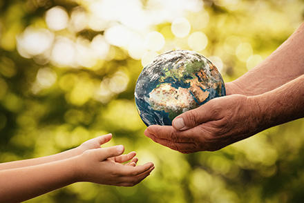 Hands carrying a globe